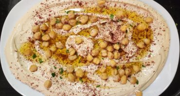 Hummus with olive oil, sumac, and chickpeas