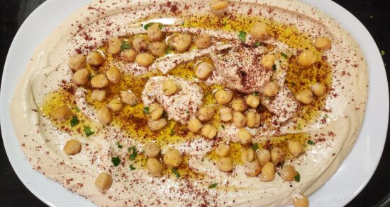 Hummus with olive oil, sumac, and chickpeas